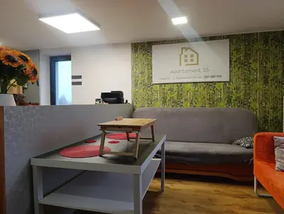 a living room with a couch and a table at Apartament 33 Skawina in Skawina