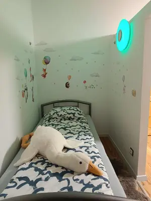 a bedroom with a bed with a stuffed swan on it at Apartament 33 Skawina in Skawina