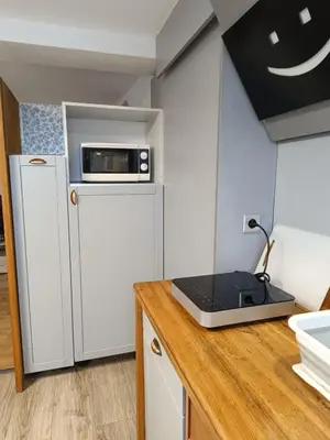 a kitchen with a refrigerator and a laptop on a counter at Apartament 33 Skawina in Skawina