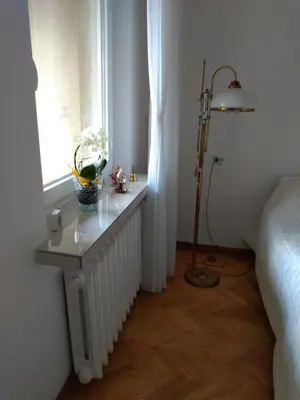 a white bathroom with a toilet and a sink at A cosy private room in the heart of old Podgorze in Kraków