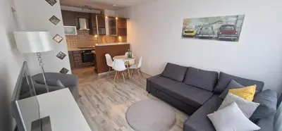 a living room with a couch and a table at Apartament Sołtysowska 10d NEAR Tauron Arena, EXPO in Kraków