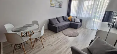 a living room with a couch and a table and chairs at Apartament Sołtysowska 10d NEAR Tauron Arena, EXPO in Kraków