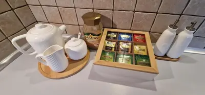 a counter top with a tea set and a pitcher and cups at Apartament Sołtysowska 10d NEAR Tauron Arena, EXPO in Kraków