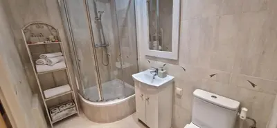 a bathroom with a shower and a toilet and a sink at Apartament Sołtysowska 10d NEAR Tauron Arena, EXPO in Kraków