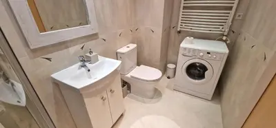 a bathroom with a toilet sink and a washing machine at Apartament Sołtysowska 10d NEAR Tauron Arena, EXPO in Kraków