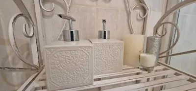a shelf with two soap dispensers and a candle at Apartament Sołtysowska 10d NEAR Tauron Arena, EXPO in Kraków