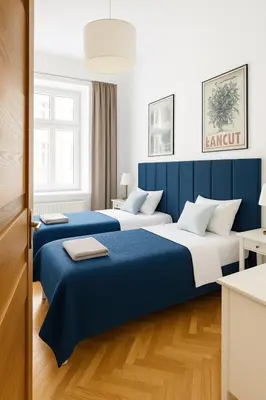 two beds in a hotel room with blue and white at Apartament przy Wawelu 80 m2 6 osób Kazimierz in Kraków