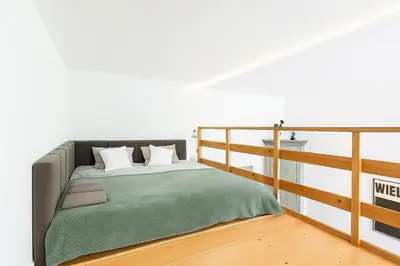 a bedroom with a bed and a balcony at Apartament przy Wawelu 80 m2 6 osób Kazimierz in Kraków