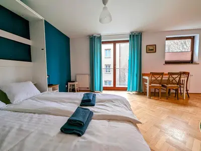 a bedroom with a large bed with blue walls at Karłowicza 12 by Homeprime in Kraków