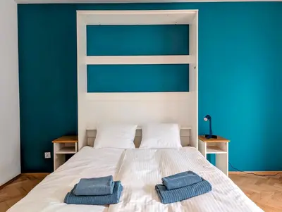 a bedroom with a bed with two towels on it at Karłowicza 12 by Homeprime in Kraków