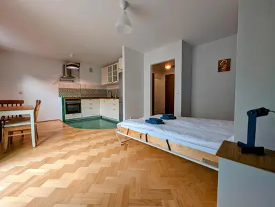 a bedroom with a bed in the middle of a room at Karłowicza 12 by Homeprime in Kraków
