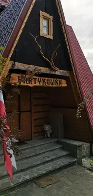a bedroom with a bed and a table and a window at willa Partykówka in Poręba Wielka