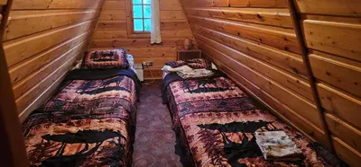 a bedroom with a bed with a quilt on it at willa Partykówka in Poręba Wielka