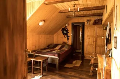 a bedroom with a bed in a wooden room at Dom Gościnny E-Lufka in Zawoja