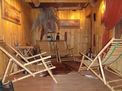 a room with rocking chairs in a wooden house at Dom Gościnny E-Lufka in Zawoja