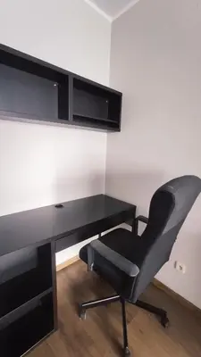a black desk with a black chair next to it at Przemysłowa 4 by Homeprime in Kraków