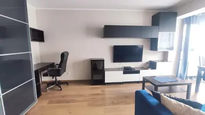 a living room with a desk and a television at Przemysłowa 4 by Homeprime in Kraków