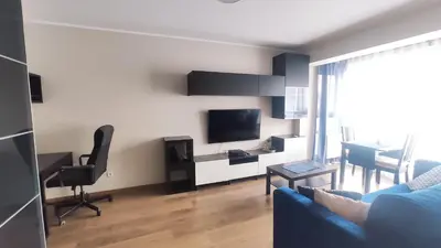 a living room with a blue couch and a tv at Przemysłowa 4 by Homeprime in Kraków
