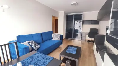 a living room with a blue couch and a table at Przemysłowa 4 by Homeprime in Kraków