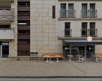 a building with benches and tables in front of it at Przemysłowa 4 by Homeprime in Kraków