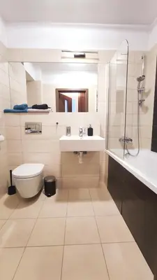 a bathroom with a toilet and a sink and a tub at Przemysłowa 4 by Homeprime in Kraków