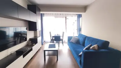 a living room with a blue couch and a table at Przemysłowa 4 by Homeprime in Kraków