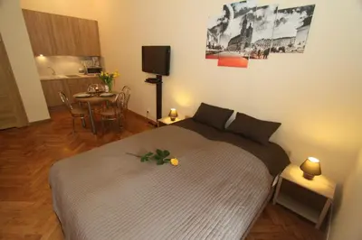 a bedroom with a bed and a table with chairs at Apartments Sobieski&Soplica in Kraków