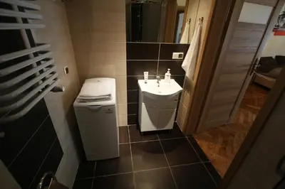 a small bathroom with a sink and a toilet at Apartments Sobieski&Soplica in Kraków