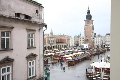 a market in a city with a clock tower at Apartments Sobieski&Soplica in Kraków