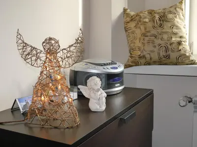 a table with a angel statue and a clock on it at Apartments Sobieski&Soplica in Kraków