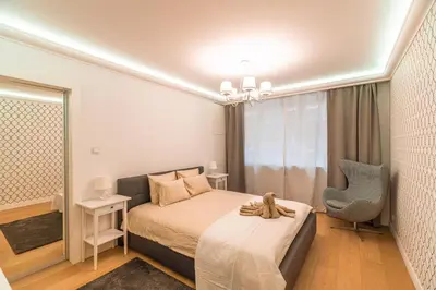 a bedroom with a bed with a teddy bear sitting on it at Heart of Kraków Comfort Apartments by Rentujemy in Kraków