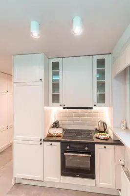 a kitchen with white cabinets and a stove top oven at Heart of Kraków Comfort Apartments by Rentujemy in Kraków