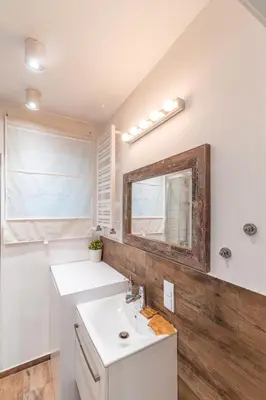 a bathroom with a sink and a mirror at Heart of Kraków Comfort Apartments by Rentujemy in Kraków