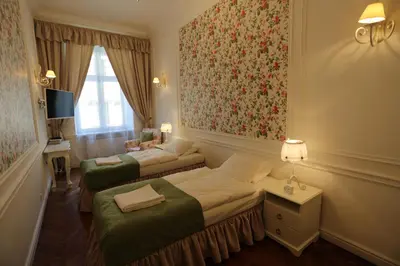 a hotel room with two beds and a window at Blueberry Apartments in Kraków
