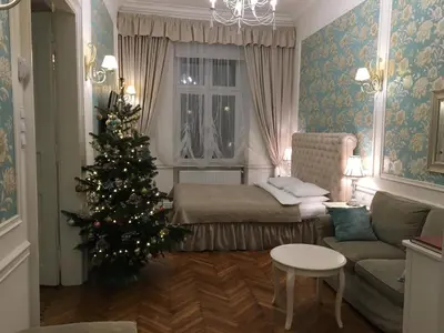 a living room with a christmas tree and a couch at Blueberry Apartments in Kraków