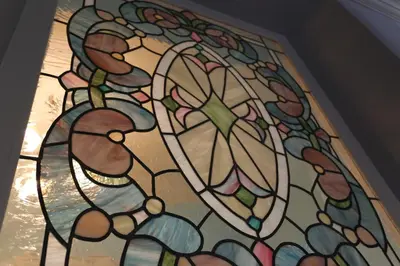 a stained glass window on the ceiling of a room at Blueberry Apartments in Kraków