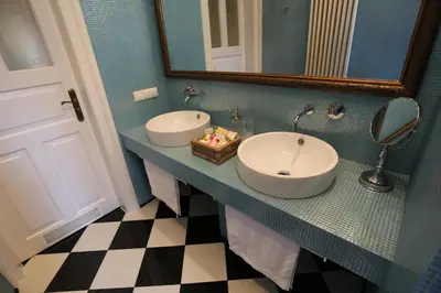 a bathroom with two sinks and a mirror at Blueberry Apartments in Kraków