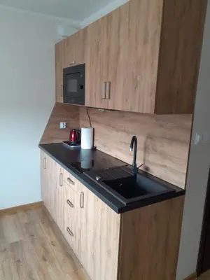 a kitchen with a sink and a microwave at Folwark Bielanka in Bielanka