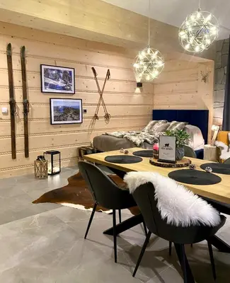 a bedroom with a wall with two pictures and a bed at OVIS HOMES APP in Zawoja