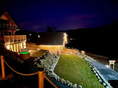 a backyard at night with lights on a house at OVIS HOMES APP in Zawoja