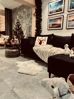 a bed with a blanket on it in a room at OVIS HOMES APP in Zawoja