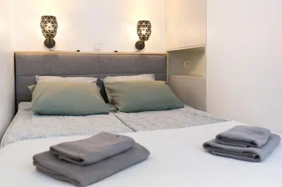 a bedroom with a bed with two towels on it at Cozy Studio for couples - Cracow city heart in Kraków