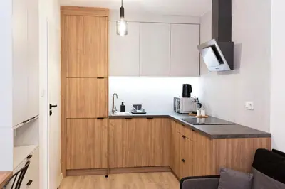 a small kitchen with a sink and a microwave at Cozy Studio for couples - Cracow city heart in Kraków