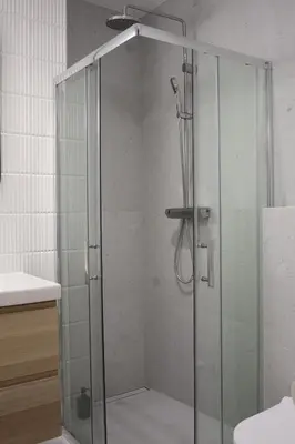 a shower with a glass door in a bathroom at Cozy Studio for couples - Cracow city heart in Kraków
