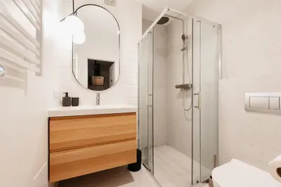 a bathroom with a shower and a sink and a mirror at Cozy Studio for couples - Cracow city heart in Kraków
