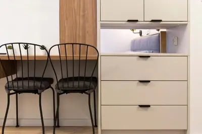 a table and two chairs next to a dresser at Cozy Studio for couples - Cracow city heart in Kraków