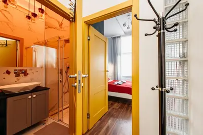 a bathroom with yellow walls and a sink and a mirror at Charming 2-Room Apartment Near Wawel Castle in Kraków