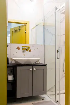 a bathroom with a sink and a shower at Charming 2-Room Apartment Near Wawel Castle in Kraków