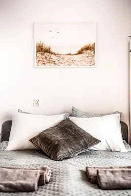 a bedroom with a bed with a picture on the wall at Fully-furnished Apartment with Air Conditioning for families, Cracow Old Town in Kraków