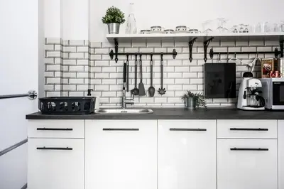 a kitchen with white cabinets and a sink at Fully-furnished Apartment with Air Conditioning for families, Cracow Old Town in Kraków